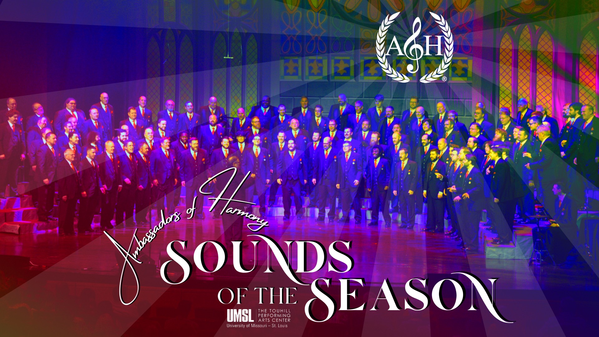Logo of the Ambassadors of Harmony performing in a colorful "Sounds of the Season" event. The image features a large male chorus standing on stage.